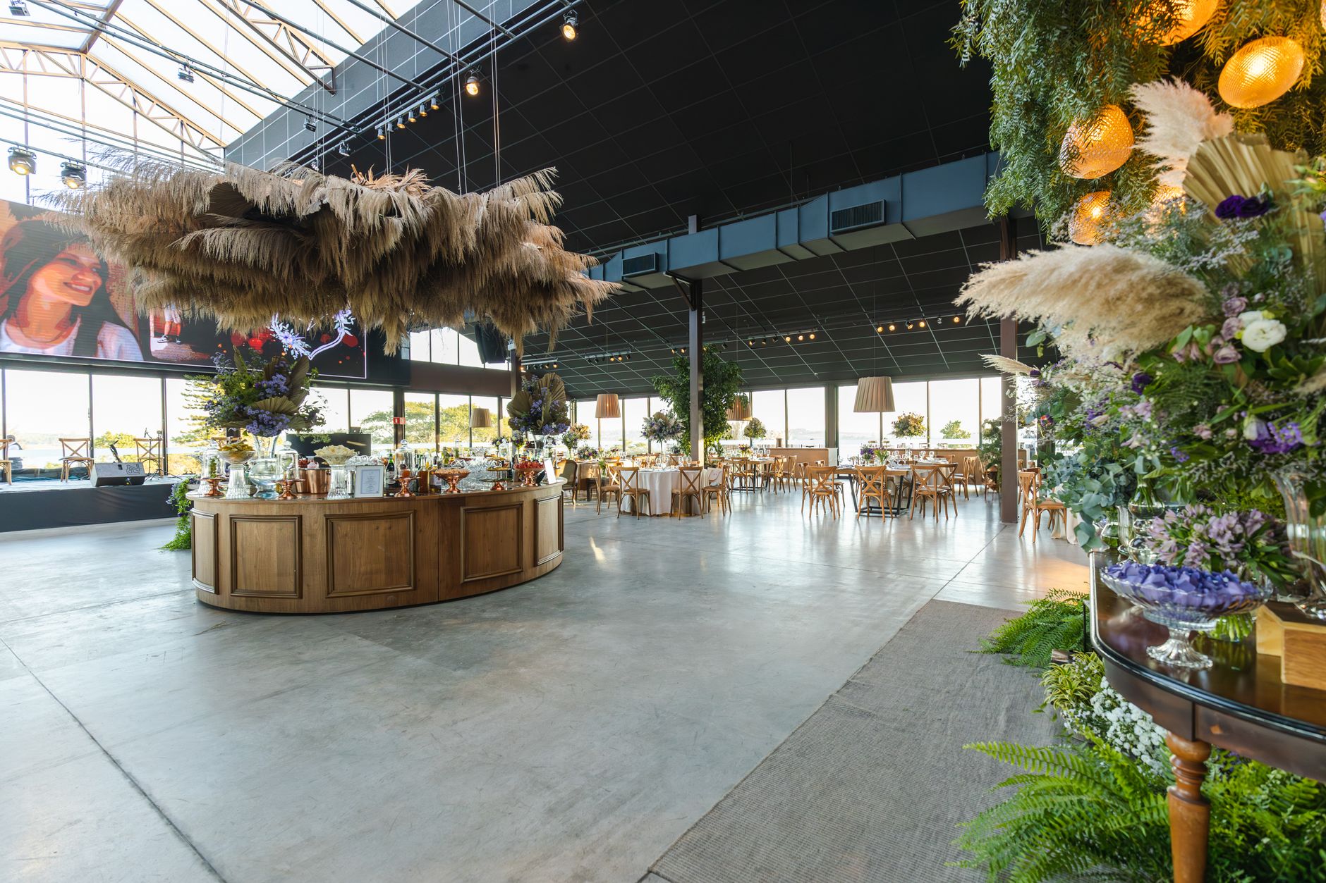 Stylish indoor wedding venue with rustic decor and floral elegance, perfect for a spacious celebration. — Download