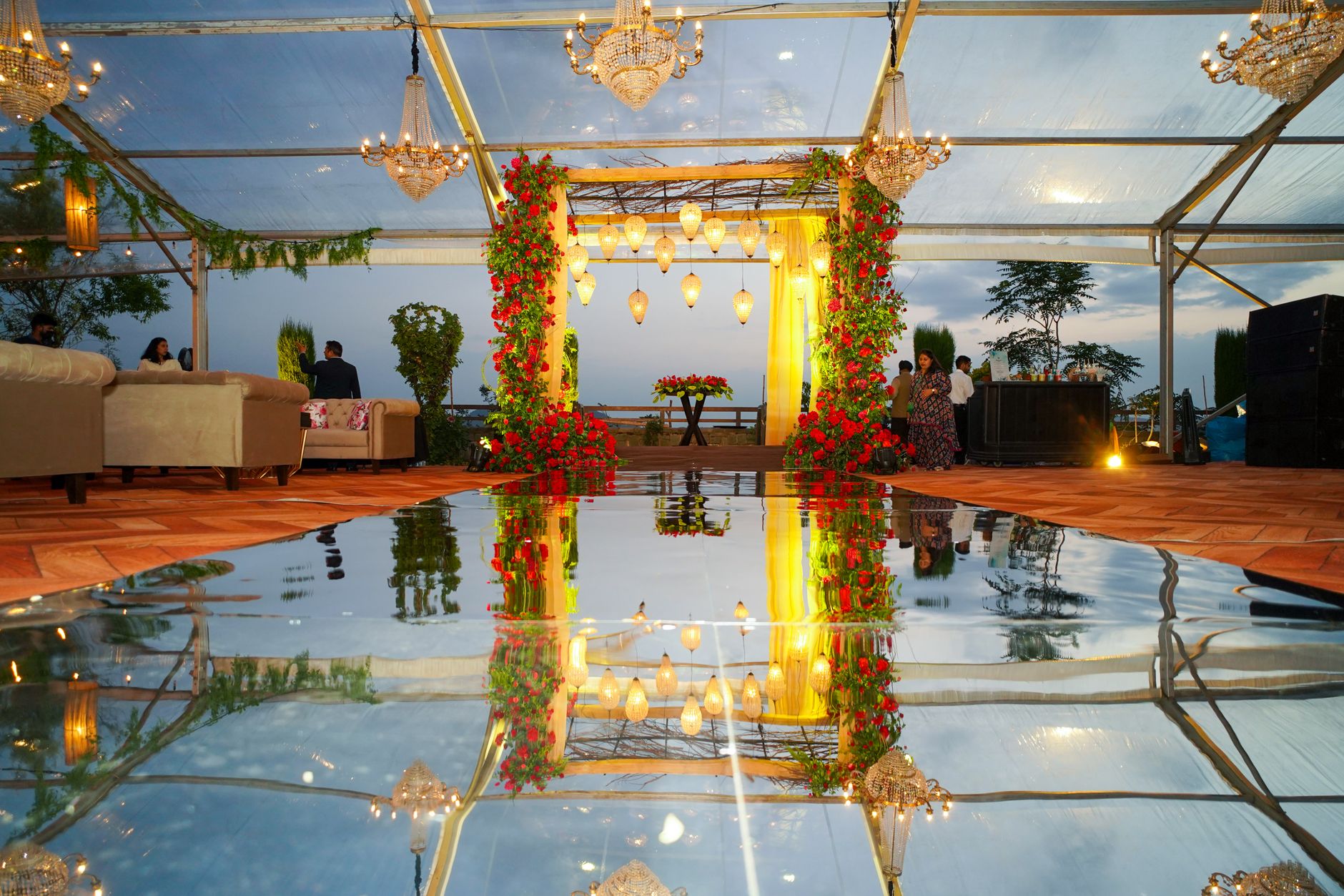 Chic indoor event setup with chandeliers, floral decor, and mirrored reflections during dusk. — Why Transaction History, a dA